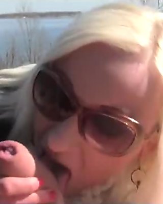 Blonde big tit MILF give blowjob in woods